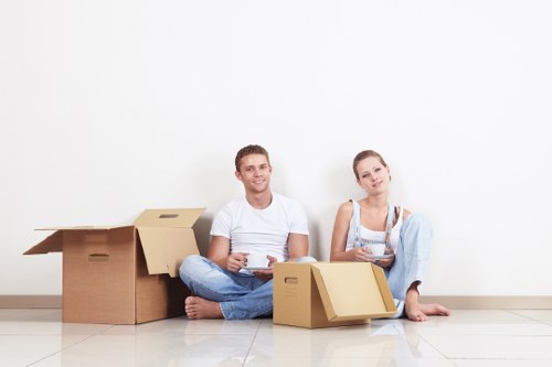 Professional movers transporting office furniture for a Harrow business