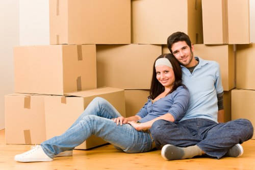 Professional movers carrying furniture through a property entrance