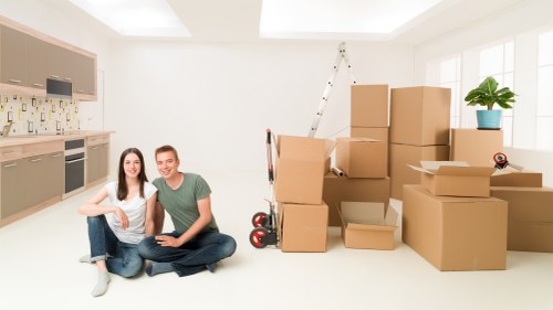 Mover assessing a heavy item before lifting during a house move