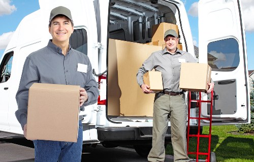 Final moving day arrangements with boxes and furniture in Harrow