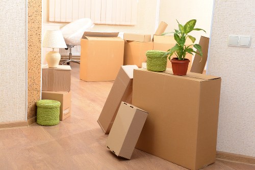 Trained movers using PPE during a Harrow removal service